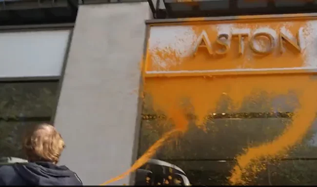 On Camera, UK Activists Spray Paint On Aston Martin Showroom In London